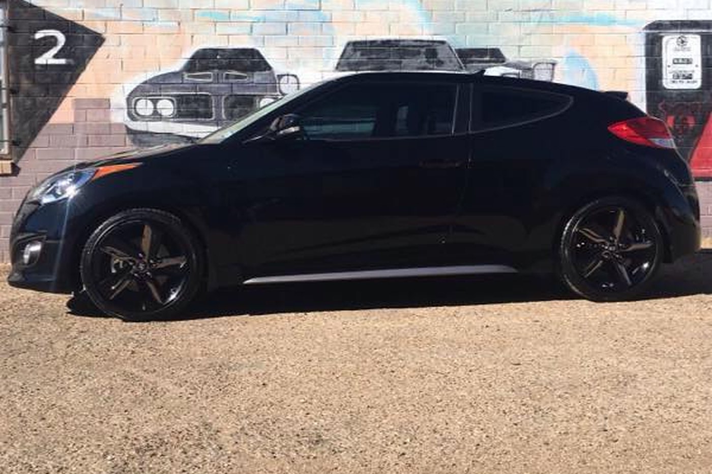Black Hyundai Veloster with mirror-deep paint finish after buffing at AJ's Auto Rehab