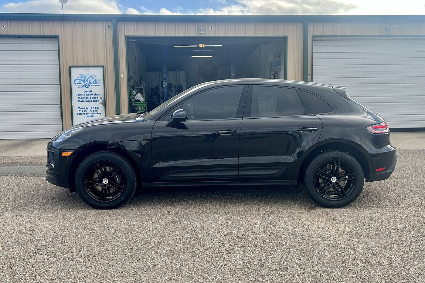 Black Porsche Macan fully detailed outside AJ's Auto Rehab shop