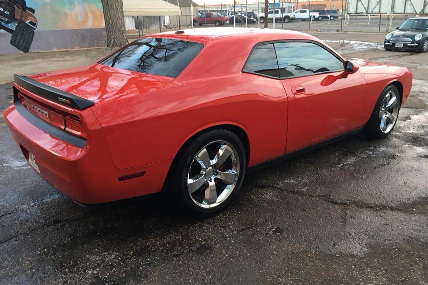 Red Challenger rear-quarter view after hand wash at AJ's Auto Rehab