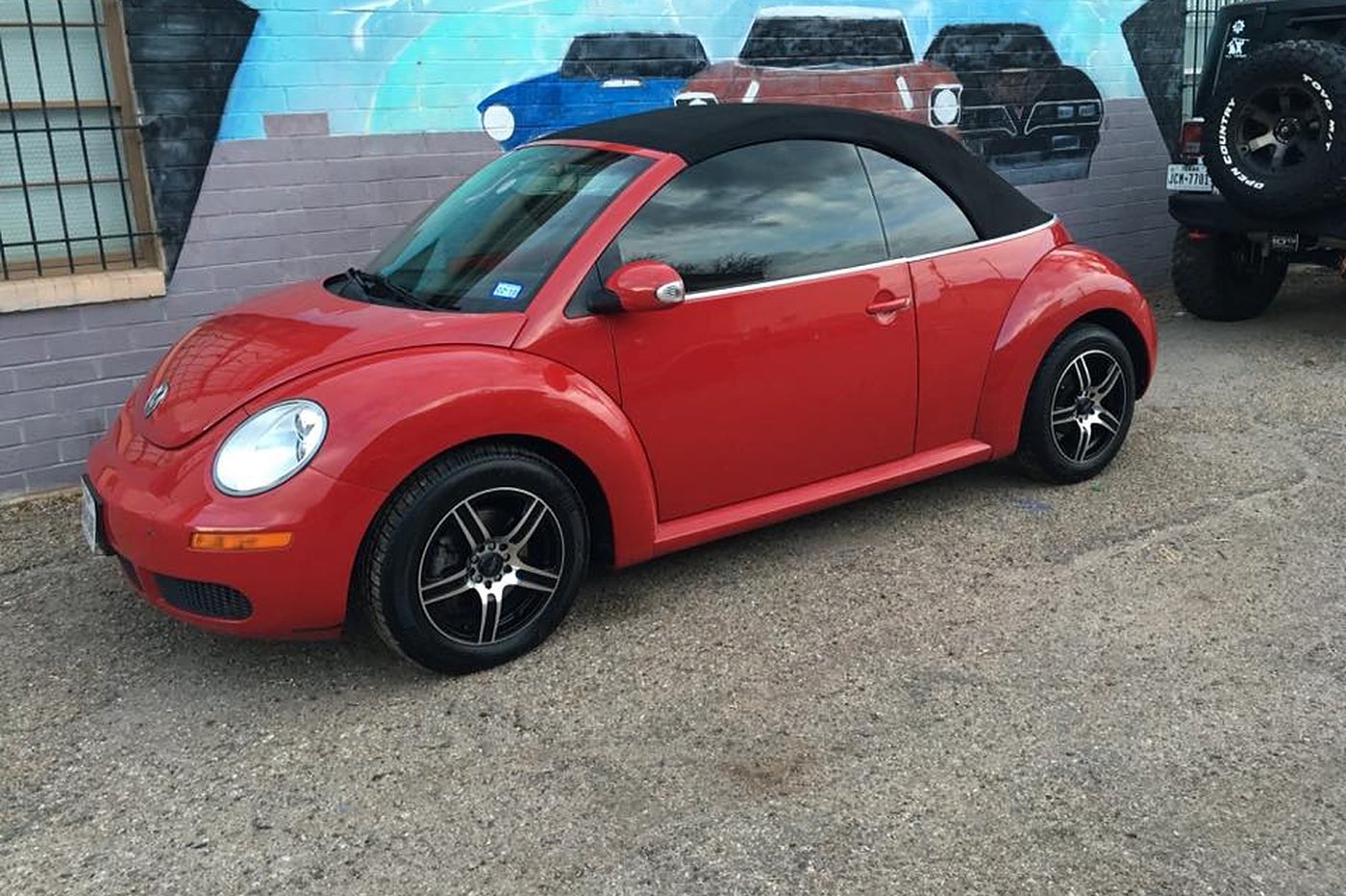 Red Beetle with deep glossy paint finish at AJ's Auto Rehab shop
