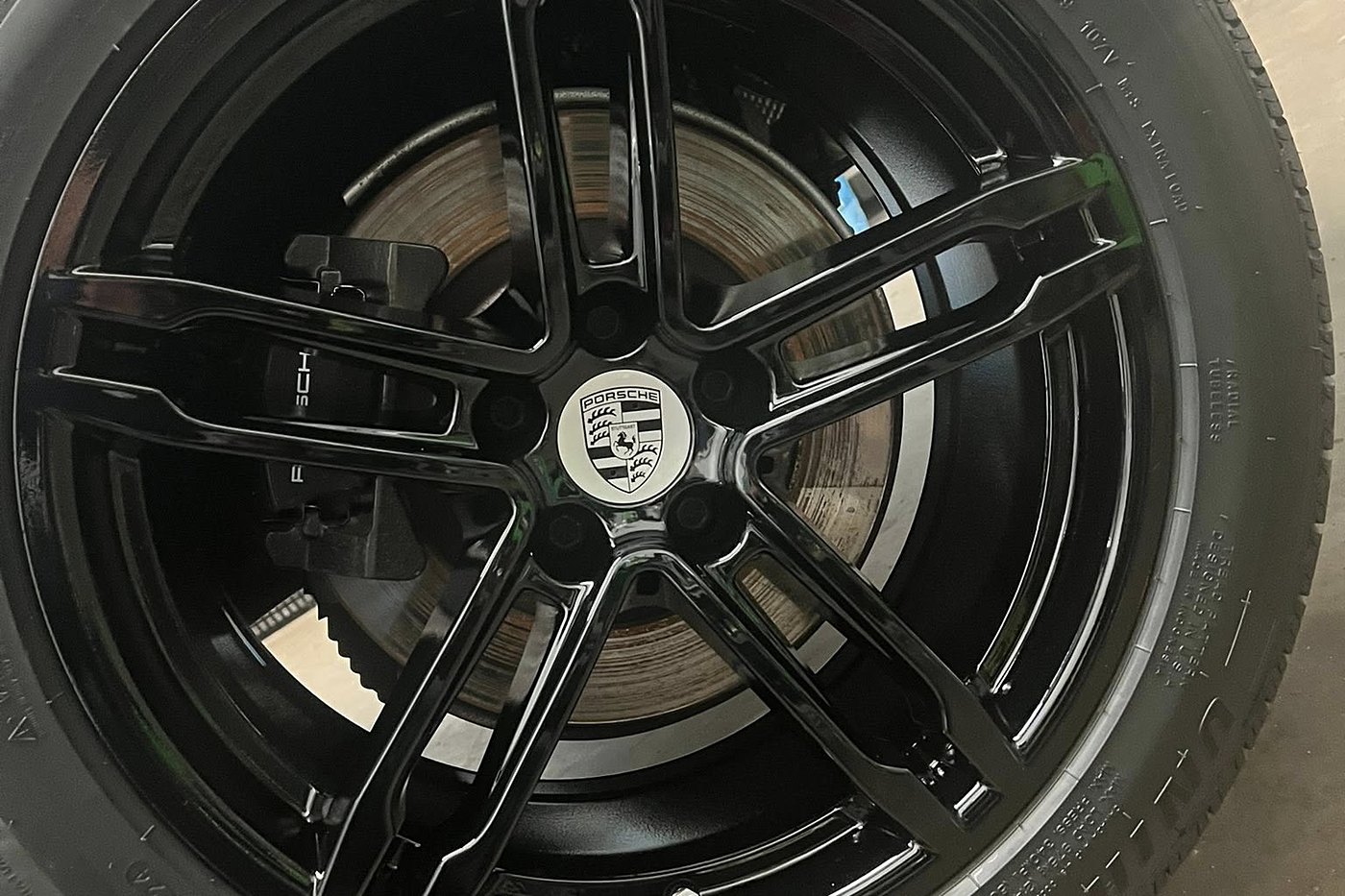 Glossy black Porsche wheel detailed to a mirror finish at AJ's Auto Rehab